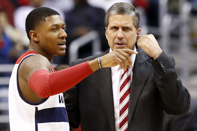 Washington Wizards guard Bradley Beal, left, talks with head coach Randy Wittman in the first half of an NBA basketball game against the Golden State Warriors, Sunday, Jan. 5, 2014, in Washington. The Warriors won 112-96 for the team's ninth win in a row. (AP Photo/Alex Brandon)