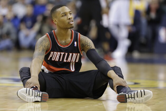 Portland Trail Blazers guard Damian Lillard after committing a foul in the first half of an NBA basketball game  against the Indiana Pacers in Indianapolis, Friday, Feb. 7, 2014.  (AP Photo/Michael Conroy)