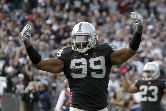 Oakland Raiders defensive end Lamarr Houston (99) against Jacksonville Jaguars defensive end Austen Lane (92) during the second half of an NFL football game in Oakland, Calif., Sunday, Oct. 21, 2012. (AP Photo/Rich Pedroncelli)