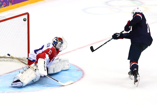 SOCHI, RUSSIA - FEBRUARY 15:  T.J. Oshie #74 of the United States scores on a shootout against Sergei Bobrovski #72 of Russia during the Men's Ice Hockey Preliminary Round Group A game on day eight of the Sochi 2014 Winter Olympics at Bolshoy Ice Dome on February 15, 2014 in Sochi, Russia.  (Photo by Clive Mason/Getty Images)