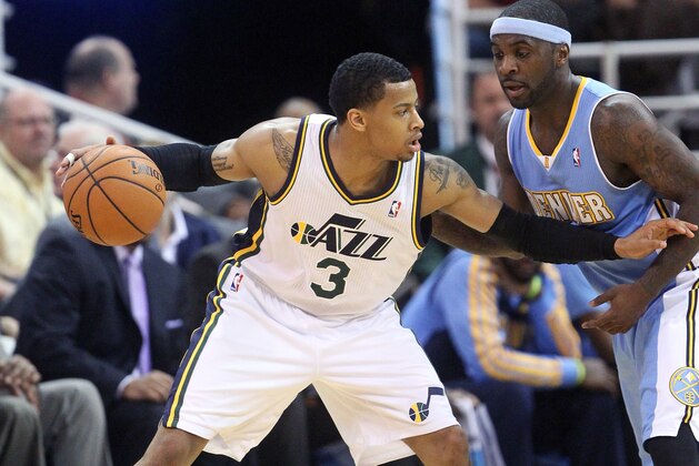 Denver Nuggets' Ty Lawson, right, defends against Utah Jazz's Trey Burke (3) in the second half during an NBA basketball game Monday, Jan. 13, 2014, in Salt Lake City. (AP Photo/Rick Bowmer)