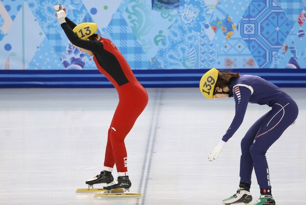 Zhou Yang of China, left, crosses the finish line ahead of Shim Suk-Hee of South Korea in a women's 1500m short track speedskating final at the Iceberg Skating Palace during the 2014 Winter Olympics, Saturday, Feb. 15, 2014, in Sochi, Russia. (AP Photo/Vadim Ghirda)