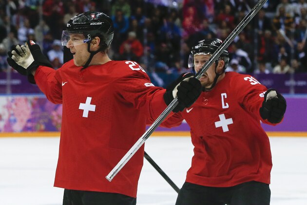 Switzerland forward Simon Bodenmann celebrates with Switzerland defenseman Mathias Seger after scoring a goal against the Czech Republic in the first period of a men's ice hockey game at the 2014 Winter Olympics, Saturday, Feb. 15, 2014, in Sochi, Russia. (AP Photo/Julio Cortez)
