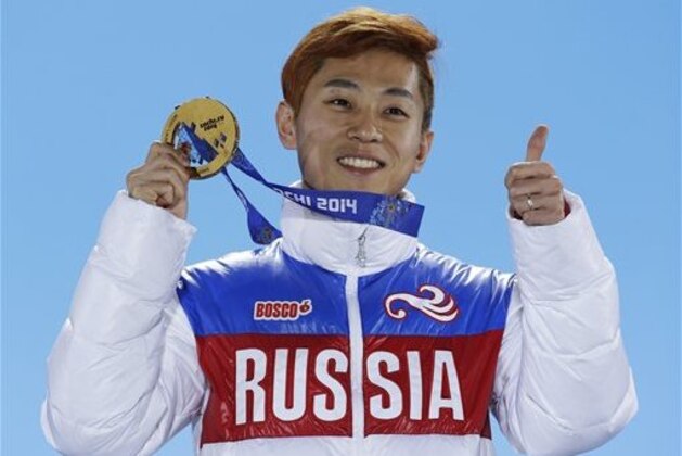 Men's 1,000-meter short track speedskating gold medalist Viktor Ahn of Russia gestures while holding his medal during the medals ceremony at the 2014 Winter Olympics, Saturday, Feb. 15, 2014, in Sochi, Russia. (AP Photo/David J. Phillip )