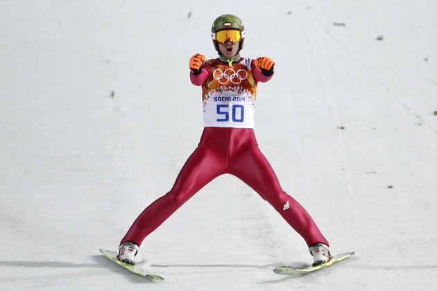 Poland's Kamil Stoch celebrates after his first attempt during the ski jumping large hill final at the 2014 Winter Olympics, Saturday, Feb. 15, 2014, in Krasnaya Polyana, Russia. (AP Photo/Gregorio Borgia)
