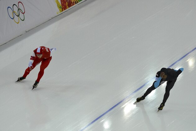 Gold medallist Poland's Zbigniew Brodka, in red, and Shani Davis of the U.S. compete in the men's 1,500-meter speedskating race at the Adler Arena Skating Center during the 2014 Winter Olympics in Sochi, Russia, Saturday, Feb. 15, 2014. (AP Photo/Antonin Thuillier, Pool)