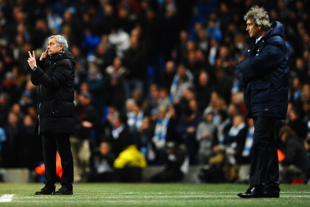 MANCHESTER, ENGLAND - FEBRUARY 03:  Manuel Pellegrini manager of Manchester City looks on as  Jose Mourinho manager of Chelsea give instructions during the Barclays Premier League match between Manchester City and Chelsea at Etihad Stadium on February 3, 2014 in Manchester, England.  (Photo by Laurence Griffiths/Getty Images)