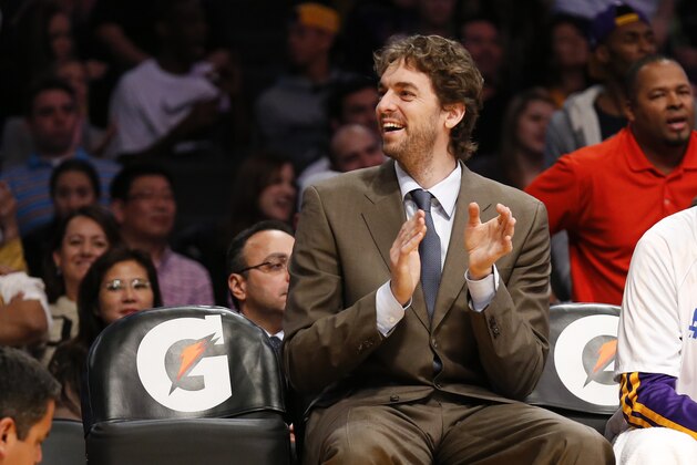 Los Angeles Lakers' Pau Gasol of Spain, who is injured, smiles on the bench against the Utah Jazz during the second half of an NBA basketball game in Los Angeles, Tuesday, Feb. 11, 2014. The Jazz won 96-79. (AP Photo/Danny Moloshok)