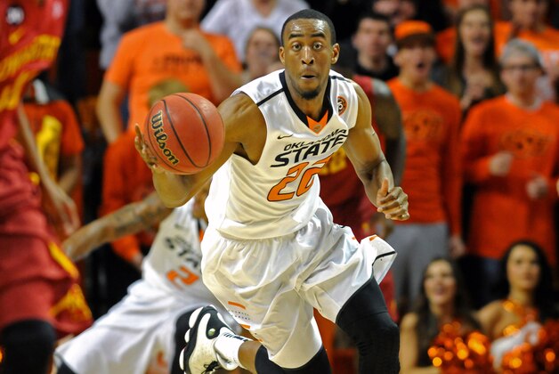 Oklahoma State wing Markel Brown drives the ball down court during an NCAA college basketball game in Stillwater, Okla., Monday, Feb. 3, 2014. (AP Photo/Brody Schmidt)