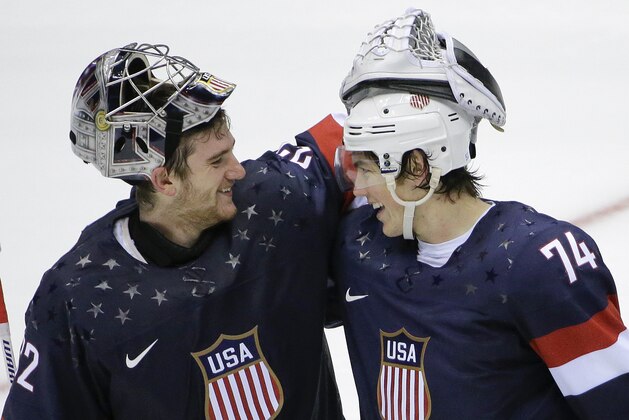 USA goaltender Jonathan Quick greets forward T.J. Oshie after Oshie scored the winning goal against Russia in a shootout during overtime of a men's ice hockey game at the 2014 Winter Olympics, Saturday, Feb. 15, 2014, in Sochi, Russia. (AP Photo/David J. Phillip )