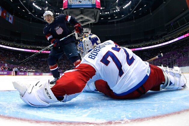 SOCHI, RUSSIA - FEBRUARY 15:  T.J. Oshie #74 of the United States shoots on a shootout against Sergei Bobrovski #72 of Russia during the Men's Ice Hockey Preliminary Round Group A game on day eight of the Sochi 2014 Winter Olympics at Bolshoy Ice Dome on February 15, 2014 in Sochi, Russia.  (Photo by Bruce Bennett/Getty Images)