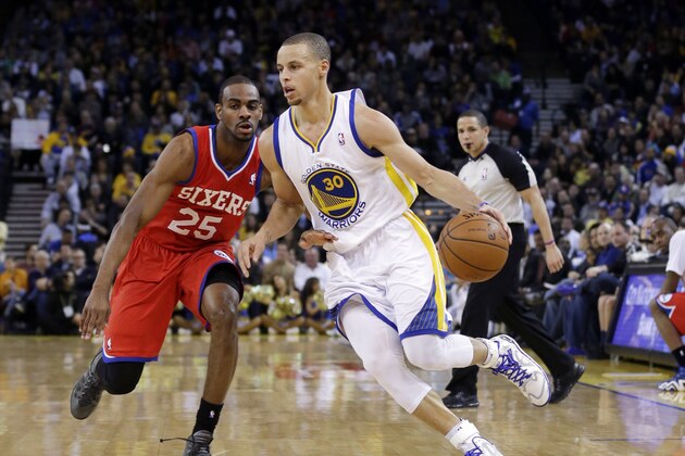 Golden State Warriors' Stephen Curry (30) dribbles next to Philadelphia 76ers' Elliot Williams (25) during the second half of an NBA basketball game on Monday, Feb. 10, 2014, in Oakland, Calif. (AP Photo/Marcio Jose Sanchez)