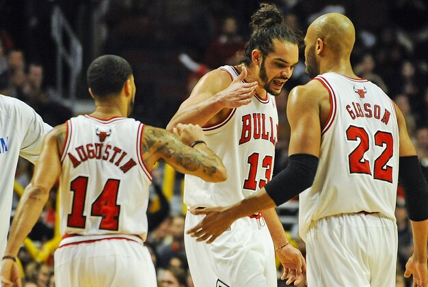 Feb 11, 2014; Chicago, IL, USA; Chicago Bulls point guard D.J. Augustin (14), Chicago Bulls center Joakim Noah (13) and Chicago Bulls power forward Taj Gibson (22) celebrate scoring in the second half against the Atlanta Hawks at the United Center. The Bulls beat the Hawks 100-85. Mandatory Credit: Matt Marton-USA TODAY Sports