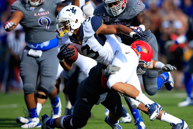 LAWRENCE, KS - NOVEMBER 16:  Running back Charles Sims #3 of the West Virginia Mountaineers carries the ball during the game against the Kansas Jayhawks at Memorial Stadium on November 16, 2013 in Lawrence, Kansas.  (Photo by Jamie Squire/Getty Images)