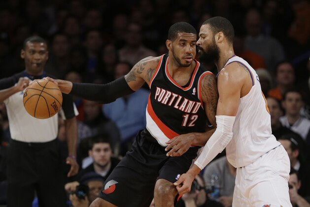 New York Knicks' Tyson Chandler (6) defends Portland Trail Blazers' LaMarcus Aldridge (12) during the first half of an NBA basketball game Wednesday, Feb. 5, 2014, in New York. (AP Photo/Frank Franklin II)