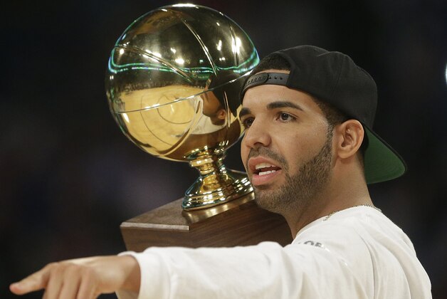 Rapper Drake walks on the court during the skills competition at the NBA All Star basketball game, Saturday, Feb. 15, 2014, in New Orleans. (AP Photo/Gerald Herbert)