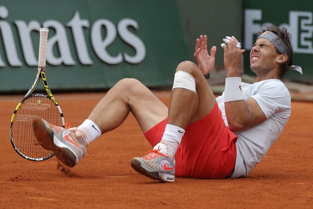 Spain's Rafael Nadal falls as he defeats compatriot David Ferrer during the men's final match of the French Open tennis tournament at the Roland Garros stadium Sunday, June 9, 2013 in Paris. Nadal won 6-3, 6-2, 6-3. (AP Photo/Michel Euler)