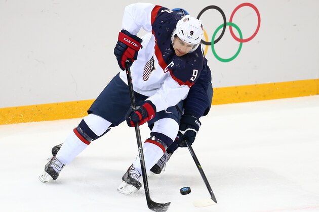 SOCHI, RUSSIA - FEBRUARY 13:  Zach Parise #9 of United States controls the puck against Slovakia during the Men's Ice Hockey Preliminary Round Group A game on day six of the Sochi 2014 Winter Olympics at Shayba Arena on February 13, 2014 in Sochi, Russia.  (Photo by Streeter Lecka/Getty Images)