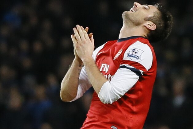 Arsenal's Olivier Giroud reacts in frustration to missing a chance to score a goal during the English Premier League soccer match between Arsenal and Everton at the Emirates Stadium in London, Sunday, Dec. 8, 2013. (AP Photo/Kirsty Wigglesworth)