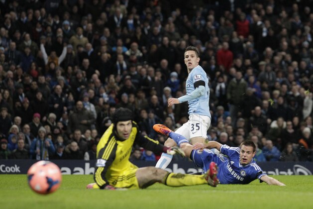 Manchester City's Steven Jovetic, top, scores past Chelsea's goalkeeper Petr Cech, left, as Cesar Azpilicueta looks towards the ball during their English FA Cup fifth round soccer match at the Etihad Stadium, Manchester, England, Saturday, Feb. 15, 2014. (AP Photo/Jon Super)
