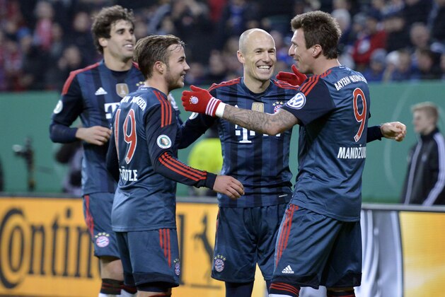 Bayern's Mario Mandzukic of Croatia, right, celebrates his third goal with Arjen Robben, Mario Goetze and Javier Martinez, from left, during the  quarterfinal match of the German soccer cup between Hamburger SV and Bayern Munich in Hamburg, Germany, Wednesday, Feb. 12, 2014. (AP Photo/Martin Meissner)