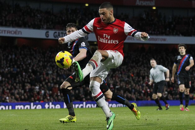 Arsenal's Alex Oxlade-Chamberlain, right, scores against Crystal Palace during their English Premier League soccer match at Emirates Stadium in London, Sunday, Feb. 2, 2014. (AP Photo/Sang Tan)