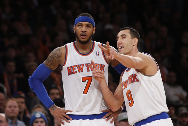 New York Knicks' Carmelo Anthony (7) talks to teammate Pablo Prigioni (9), of Argentina, during the second half of an NBA basketball game against the Miami Heat Saturday, Feb. 1, 2014, in New York.  Miami won 106-91.  (AP Photo/Jason DeCrow)