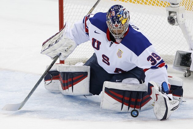USA goaltender Ryan Miller stops a shot on the goal during the 2014 Winter Olympics men's ice hockey game against Slovenia at Shayba Arena Sunday, Feb. 16, 2014, in Sochi, Russia. (AP Photo/Petr David Josek)