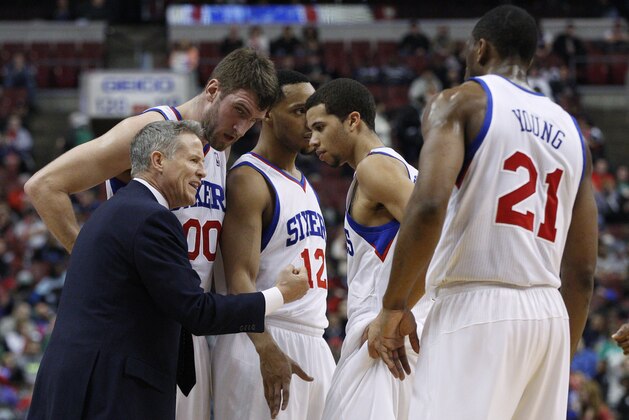 Philadelphia 76ers head coach Brett Brown, left, talks things over with his team; (left to right) Spencer Hawes, Evan Turner, Michael Carter-Williams, and Thaddeus Young during the first half of an NBA basketball game against the Boston Celtics, Wednesday, Feb. 5, 2014, in Philadelphia. The Celtics won 114-108. (AP Photo/Chris Szagola)