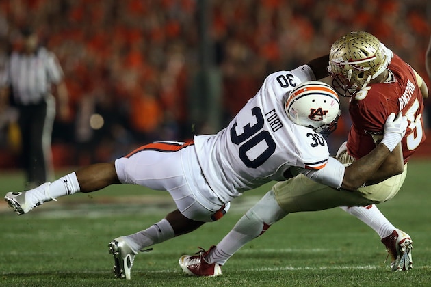 PASADENA, CA - JANUARY 06:  Quarterback Jameis Winston #5 of the Florida State Seminoles is sacked by defensive end Dee Ford #30 of the Auburn Tigers during the 2014 Vizio BCS National Championship Game at the Rose Bowl on January 6, 2014 in Pasadena, California.  (Photo by Stephen Dunn/Getty Images)