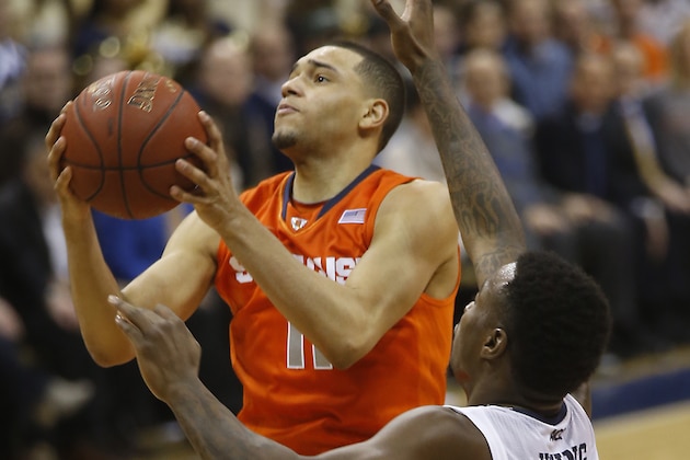 Syracuse's Tyler Ennis (11) shoots past Pittsburgh's Michael Young (2) during the second half of an NCAA college basketball game on Wednesday, Feb. 12, 2014, in Pittsburgh. (AP Photo/Keith Srakocic)