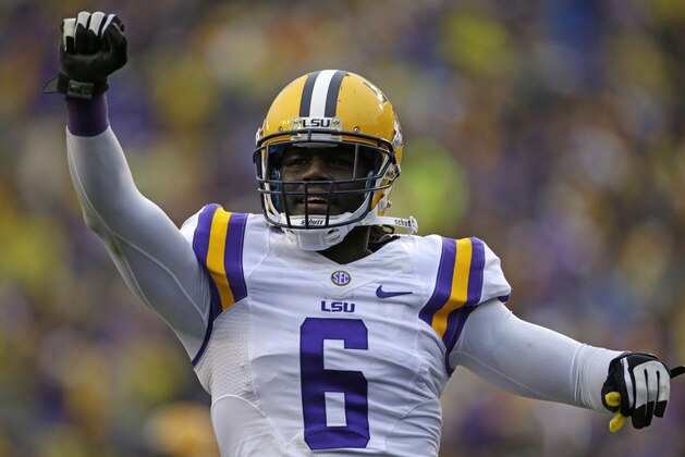 LSU safety Craig Loston (6) celebrates a defensive stop on fourth down near the LSU goal line in the first half of an NCAA college football game against Texas A&M in Baton Rouge, La., Saturday, Nov. 23, 2013. (AP Photo/Gerald Herbert)