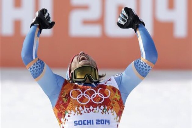 Men's super-G gold medal winner Norway's Kjetil Jansrud celebrates on the podium during a flower ceremony at the Sochi 2014 Winter Olympics, Sunday, Feb. 16, 2014, in Krasnaya Polyana, Russia. (AP Photo/Gero Breloer)
