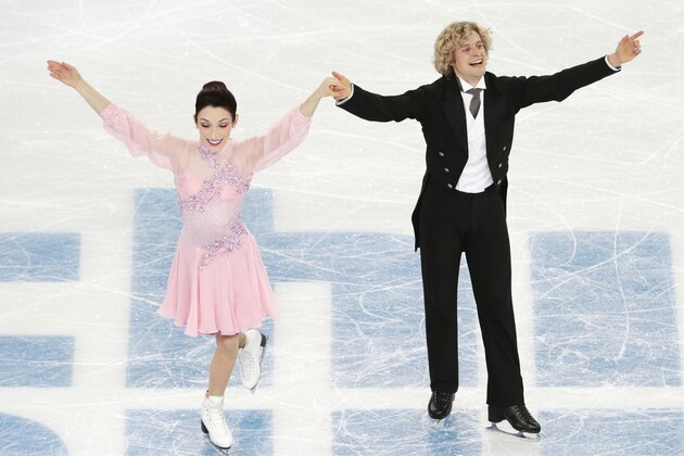 Meryl Davis and Charlie White of the United States complete their routine in the ice dance short dance figure skating competition at the Iceberg Skating Palace during the 2014 Winter Olympics, Sunday, Feb. 16, 2014, in Sochi, Russia. (AP Photo/Ivan Sekretarev)