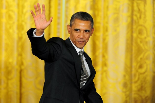Jul 31, 2013; Washington, DC, USA;  United States president Barack Obama (center) waves at the crowd during the Connecticut Huskies visit to the White House. Mandatory Credit: Evan Habeeb-USA TODAY Sports
