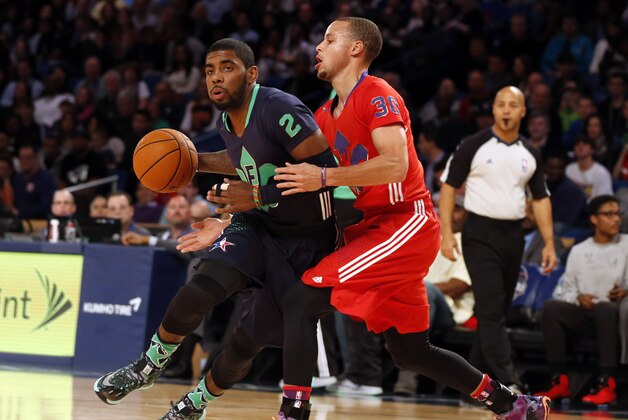 Feb 16, 2014; New Orleans, LA, USA; Eastern Conference Kyrie Irving guard (2) of the Cleveland Cavaliers dribbles around Western Conference guard Stephen Curry (30) of the Golden State Warriors during the 2014 NBA All-Star Game at the Smoothie King Center. Mandatory Credit: Derick E. Hingle-USA TODAY Sports