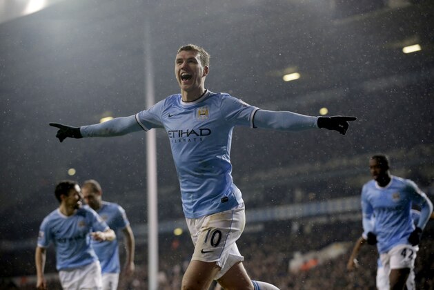 Manchester City's Edin Dzeko celebrates scoring his side's third goal during the English Premier League soccer match between Tottenham Hotspur and Manchester City at White Hart Lane stadium in London, Wednesday, Jan. 29, 2014.  (AP Photo/Matt Dunham)