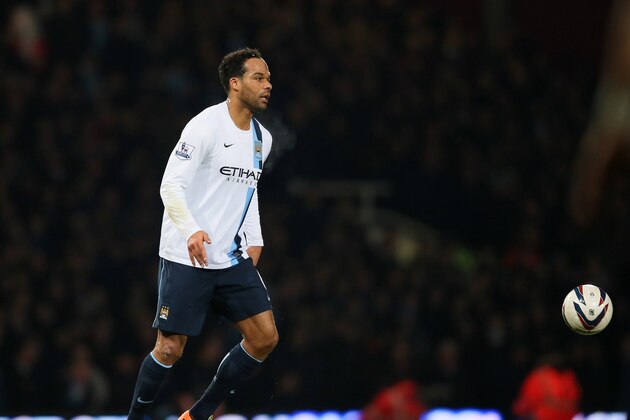 Manchester City's Joleon Lescott takes the ball forward during the second leg of the English League Cup semifinal soccer match between West Ham United and Manchester City at the Boleyn stadium in London, Tuesday, Jan 21  2014.(AP Photo/Alastair Grant)
