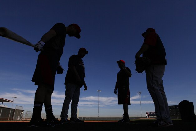 Cleveland Indians players talk during spring training baseball practice in Goodyear, Ariz., Thursday, Feb. 13, 2014. (AP Photo/Paul Sancya)