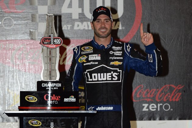 DAYTONA BEACH, FL - JULY 06:  Jimmie Johnson, driver of the #48 Lowe's Dover White Chevrolet, poses in victory lane after winning the NASCAR Sprint Cup Series Coke Zero 400 at Daytona International Speedway on July 6, 2013 in Daytona Beach, Florida.  (Photo by Tom Pennington/Getty Images)