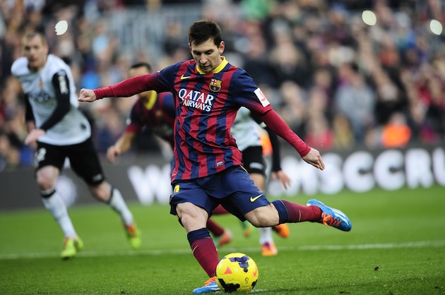 FC Barcelona's Lionel Messi, from Argentina, kicks the ball and scores from a penalty during a Spanish La Liga soccer match against Valencia,  at the Camp Nou stadium in Barcelona, Spain, Saturday, Feb. 1, 2014. (AP Photo/Manu Fernandez)