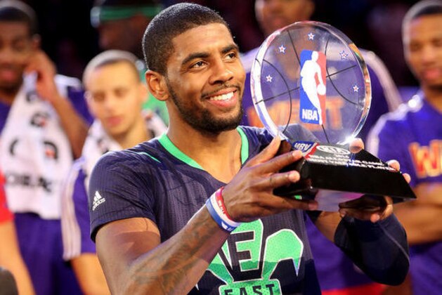 Kyrie Irving hoisting the MVP trophy of the 2014 All-Star game.