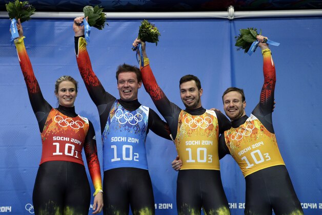 The German team of Natalie Geisenberger, in orange, Felix Loch, in blue, and doubles team of Tobias Wendl and Tobias Arlt, in yellow, pose with their flowers after winning the gold medal during the luge team relay competition at the 2014 Winter Olympics, Thursday, Feb. 13, 2014, in Krasnaya Polyana, Russia.(AP Photo/Michael Sohn) The German team of Natalie Geisenberger, in orange, Felix Loch, in blue, and doubles team of Tobias Wendl and Tobias Arlt, in yellow, pose with their flowers after winning the gold medal during the luge team relay competition at the 2014 Winter Olympics, Thursday, Feb. 13, 2014, in Krasnaya Polyana, Russia.(AP Photo/Michael Sohn)