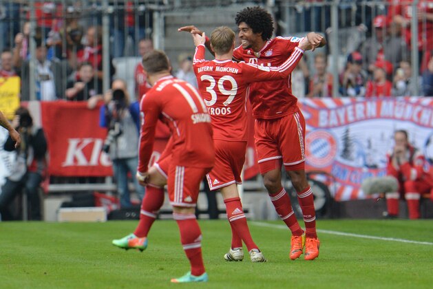 Bayern's Dante of Brazil, right, and Toni Kroos, center, celebrate after scoring during the German first division Bundesliga soccer match between FC Bayern Munich and SC Freiburg in Munich, Germany, on Saturday, Feb. 15, 2014. (AP Photo/Kerstin Joensson)