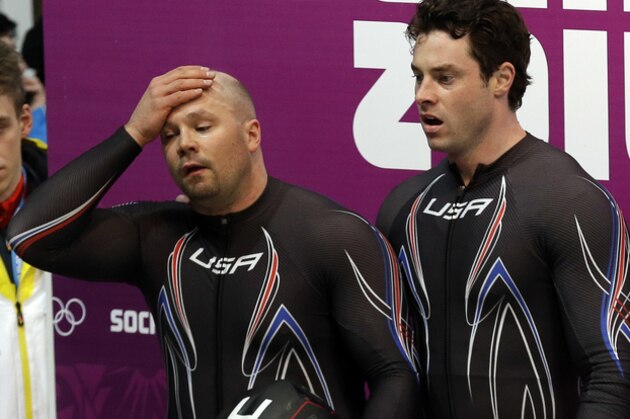 The team from the United States USA-1, piloted by Steven Holcomb and brakeman Steven Langton, react after their bronze medal finish during the men's two-man bobsled competition at the 2014 Winter Olympics, Monday, Feb. 17, 2014, in Krasnaya Polyana, Russia. (AP Photo/Natacha Pisarenko)