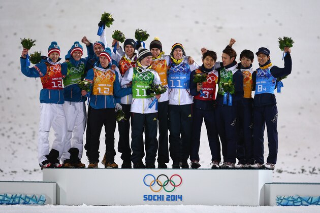 SOCHI, RUSSIA - FEBRUARY 17:  (L-R) Silver medalists Austria, gold medalists Germany and bronze medalists Japan celebrate during the flower ceremony for the Men's Team Ski Jumping final round on day 10 of the Sochi 2014 Winter Olympics at the RusSki Gorki Ski Jumping Center on February 17, 2014 in Sochi, Russia.  (Photo by Paul Gilham/Getty Images)