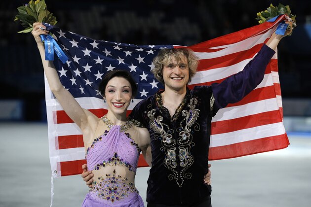Meryl Davis and Charlie White of the United States pose for photographers after placing first in the ice dance free dance figure skating finals at the Iceberg Skating Palace during the 2014 Winter Olympics, Monday, Feb. 17, 2014, in Sochi, Russia. (AP Photo/Vadim Ghirda)