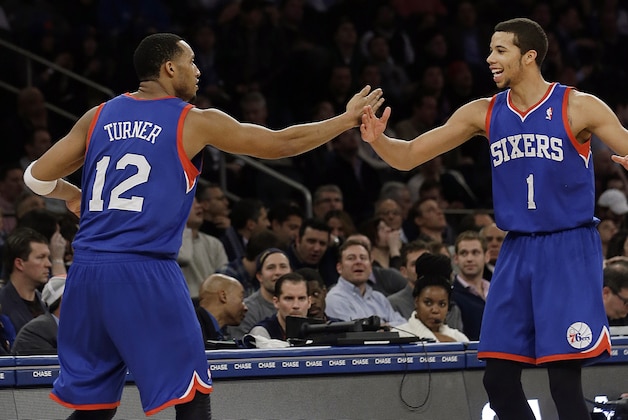 Philadelphia 76ers' Evan Turner (12) and Michael Carter-Williams (1) celebrate after Turner made a three-point basket during the second half of an NBA basketball game against the New York Knicks, Wednesday, Jan. 22, 2014, in New York. The 76ers won the game 110-106. (AP Photo/Frank Franklin II)