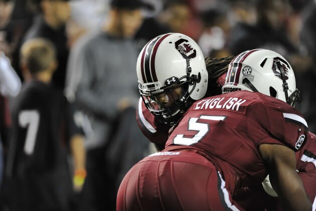 South Carolina's Jadeveon Clowney, back, runs drills with Darius English before the start of an NCAA college football game against Florida Saturday, Nov. 16, 2013, at Williams-Brice Stadium in Columbia, S.C. (AP Photo/ Richard Shiro)