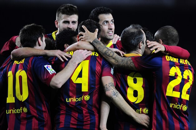 FC Barcelona's players celebrate Pedro Rodriguez's goal against Rayo Vallecano during a Spanish La Liga soccer match at the Camp Nou stadium in Barcelona, Spain, Saturday, Feb. 15, 2014. (AP Photo/Manu Fernandez)
